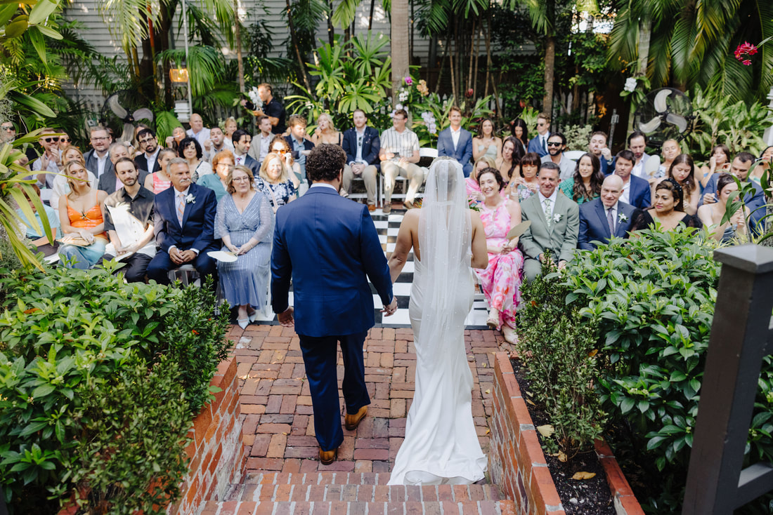 Key West wedding photographer captures ceremony under palm trees at historic venuePicture