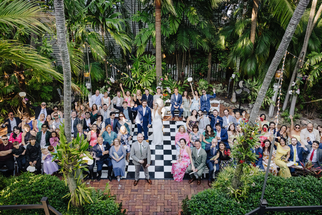 Key West wedding photographer captures ceremony under palm trees at historic venuePicture
