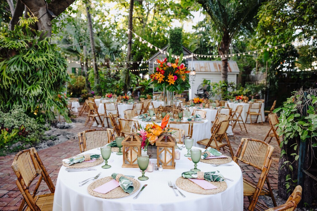Floral arch and tropical details at outdoor Audubon House wedding ceremony Picture