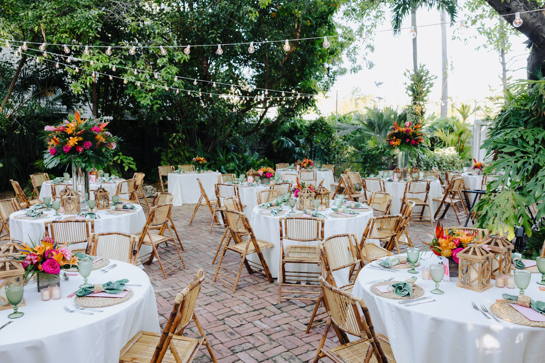 Floral arch and tropical details at outdoor Audubon House wedding ceremony Picture
