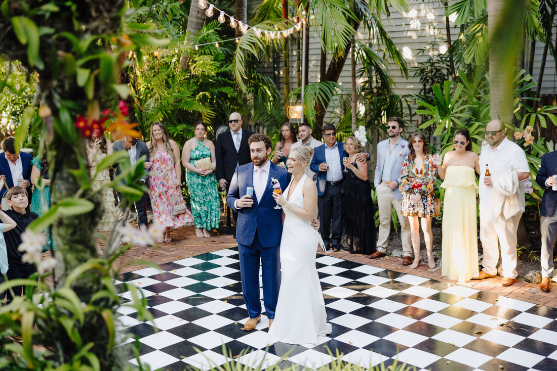 Candid moment during wedding speeches at lush Key West venue, captured by Key West photographerPicture