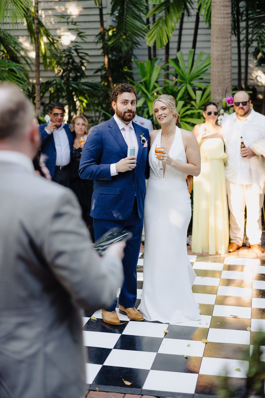 Candid moment during wedding speeches at lush Key West venue, captured by Key West photographerPicture