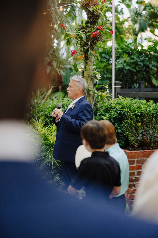 Candid moment during wedding speeches at lush Key West venue, captured by Key West photographerPicture