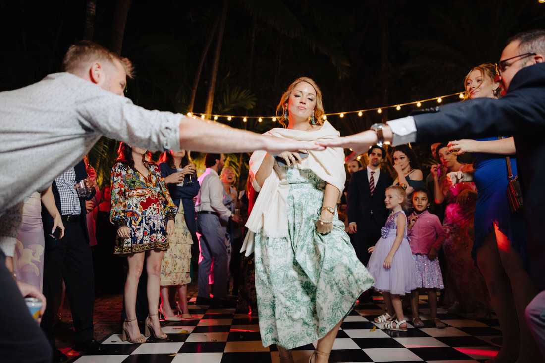 Candid moment during first dance in lush garden venue, captured by Key West wedding photographer Picture