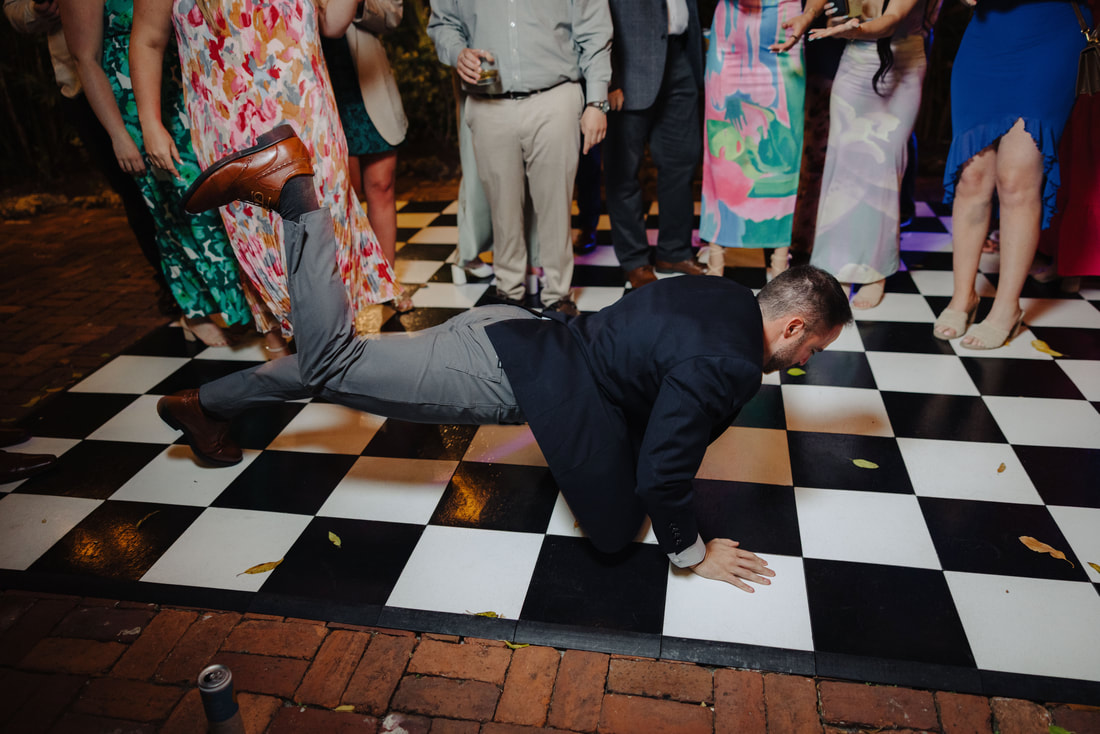 Candid moment during first dance in lush garden venue, captured by Key West wedding photographerPicture
