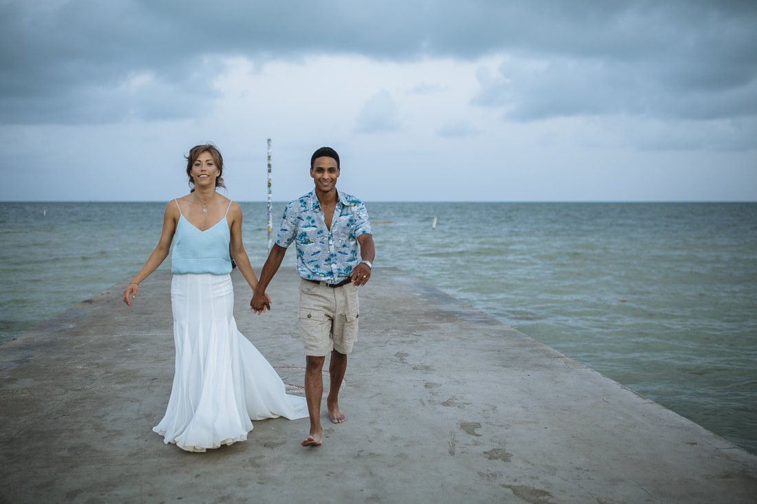Bride and Groom, Southernmost Beach Resort, Beach wedding, Reflection, Key West wedding photographer, Weddings By Romi, Bride and groom walking towards the camera