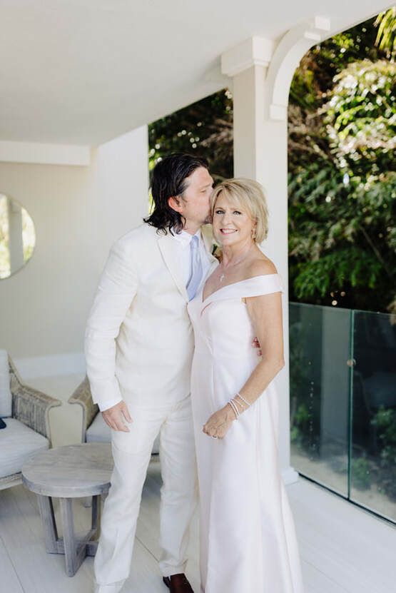 Groom kissing his mom